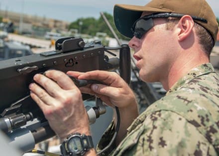 NORFOLK (July 25, 2017) Electronics Technician 1st Class Gary Holton inspects an M2HB machine gun before Coastal Riverine Squadron 4 goes on an evening training patrol. CRS-4 is currently conducting a training cycle in preparation for a future deployment. (U.S. Navy photo by Mass Communication Specialist 1st Class Patrick Enright/Released)